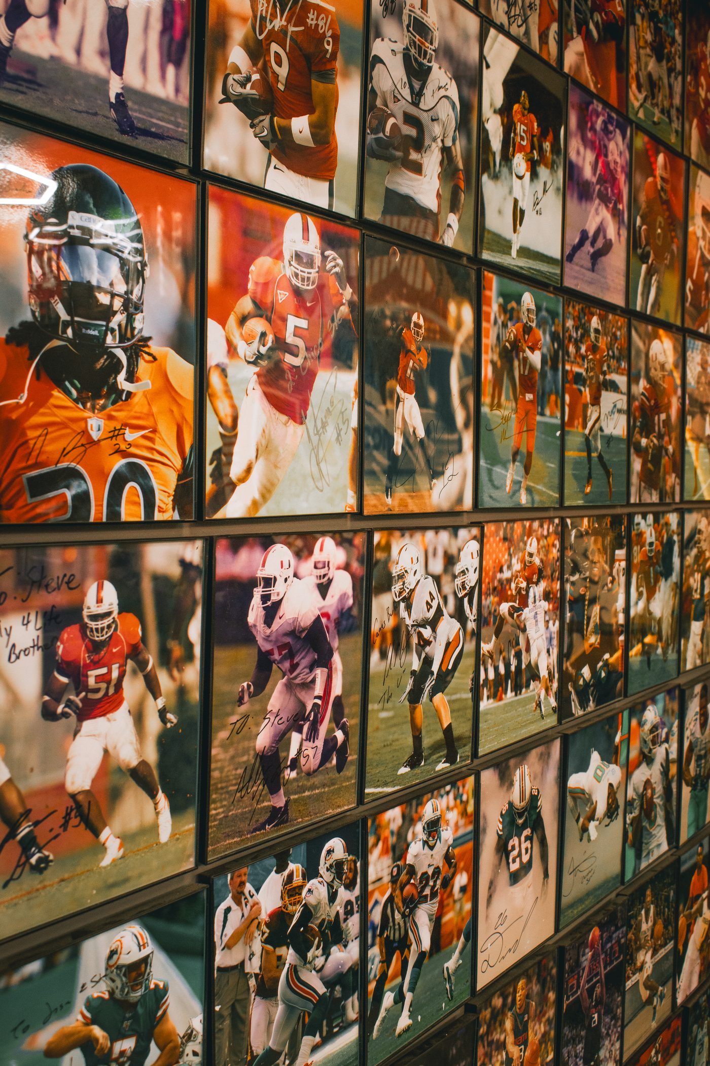 A wall of signed photos from the athletes Steven has cut