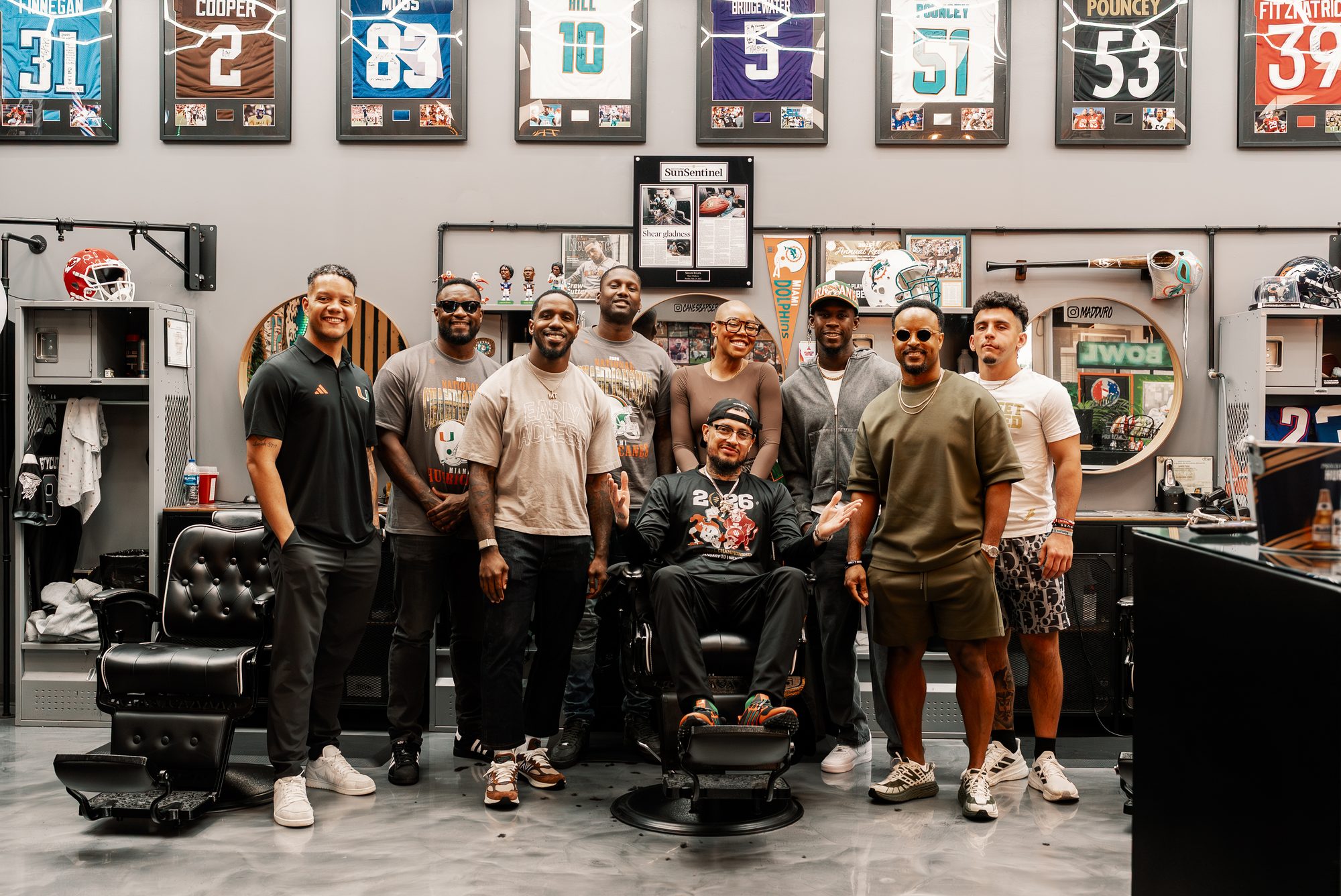 Steven in the chair surrounded by the squad at the Players Lounge